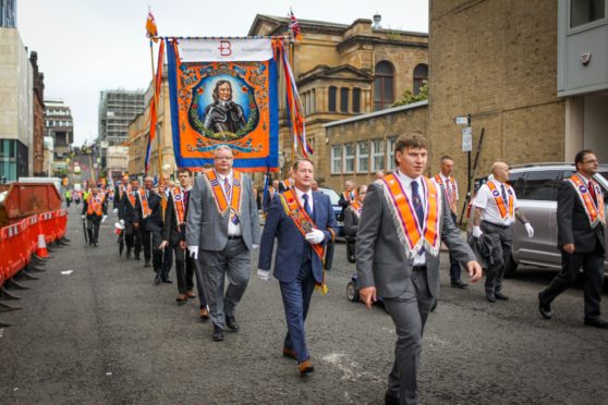 Members of the County Grand Orange Lodge take part in the annual Orange walk parade which passed though the city centre on September 18, 2021 in Glasgow.