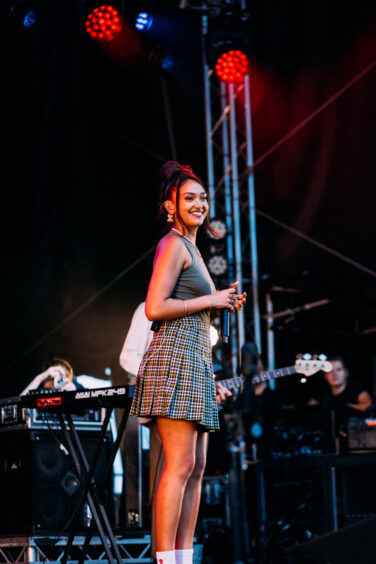 Joy Crookes dressed in tartan for the occasion