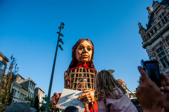 Little Amal, a giant puppet inspired by a Syrian child refugee, arrives in Antwerp as part of a journey from the Syrian border across Turkey, Greece, Italy, France, Switzerland, Germany and Belgium symbolising the search of her mother.