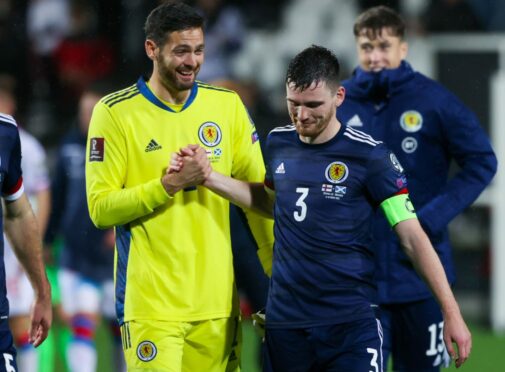 Craig 
Gordon is 
congratulated by Andy Robertson on his 
performance in Torshavn last Tuesday night.