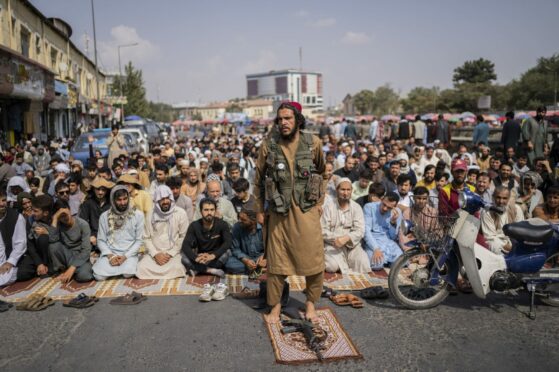 A Taliban fighter attends Friday prayers in Kabul, Afghanistan