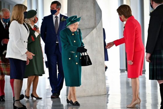 The Queen is greeted by Nicola Sturgeon as she arrives at Holyrood yesterday