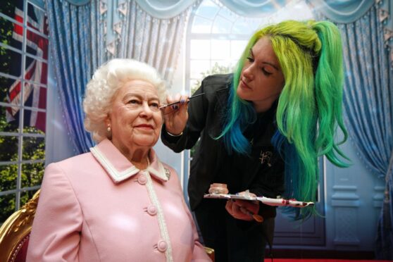 Emma Meehan puts the finishing touches to a wax figure of the Queen at Madame Tussauds last week in Blackpool