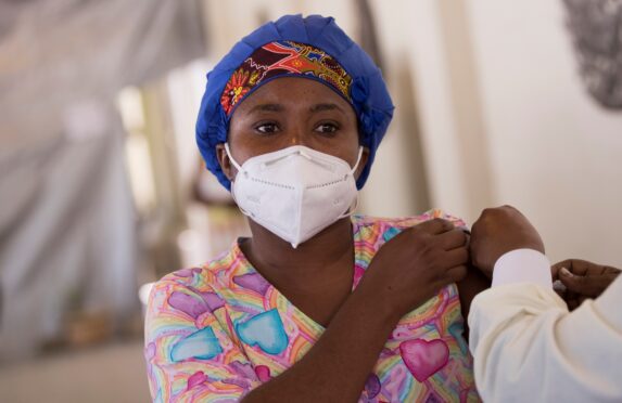 A woman receives her vaccine in Port-au-Prince, Haiti, in July