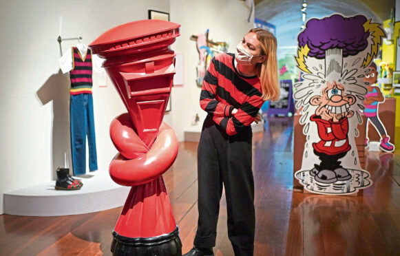 A member of staff enjoys the Beano show at Somerset House.
