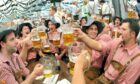 Visitors to the annual beer festival 'Oktoberfest' celebrate in Munich