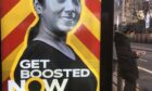 An advertising billboard in Edinburgh urges people to get their Covid booster