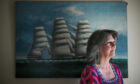 Jackie Hood stands in front of a painting of the Springbank at her home in Helensburgh