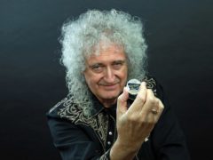 Queen guitarist Brian May with the Queen 2020 UK £5 brilliant uncirculated coin (The Royal Mint/PA)