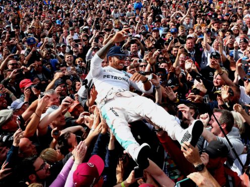 Lewis Hamilton celebrates his victory with the crowd after winning the 2016 British Grand Prix (PA)