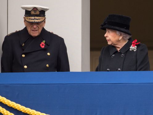 The Queen and Duke of Edinburgh stand on a Foreign Office balcony, overlooking the annual Remembrance Sunday Service at the Cenotaph in Whitehall (Dominic Lipinski/PA)