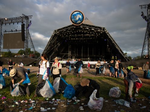 A clean-up begins in front of the pyramid stage at Glastonbury Festival (Aaron Chown/PA)