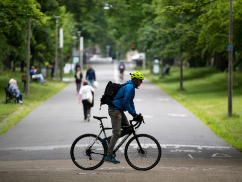 A man cycles through The Meadows in Edinburgh (Jane Barlow/PA)