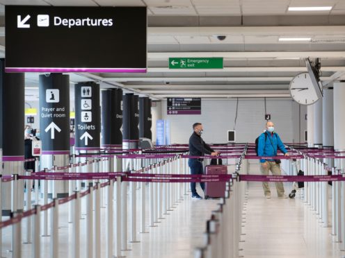 Passengers wearing a protective face masks at the Edinburgh Airport check-in area (Jane Barlow/PA)