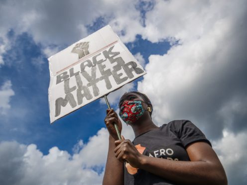 A woman holding a banner during in a Black Lives Matter protest rally at Woodhouse Moor in Leeds (Danny Lawson/PA)