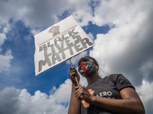 A woman holding a banner during in a Black Lives Matter protest rally at Woodhouse Moor in Leeds (Danny Lawson/PA)