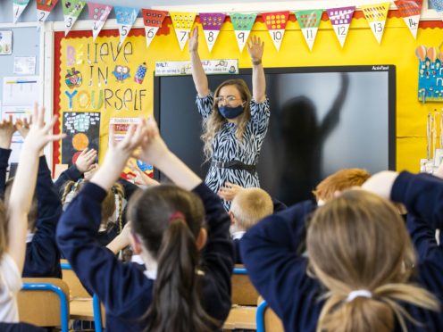 P3 teacher Jessica Cargill with her class at Springfield Primary School in Belfast (Liam McBurney/PA)
