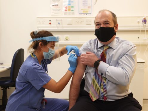 Northern Ireland Chief Medical Officer Michael McBride receives his first dose of the Oxford/AstraZeneca coronavirus vaccine (Liam McBurney/PA)