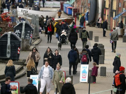 People walk along the seafront in Brighton, East Sussex (Steve Parsons/PA)