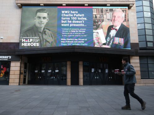 A 100th birthday message for Second World War veteran Charlie Pallett is displayed on a giant advertising screen in London’s Leicester Square (Jonathan Brady/PA)
