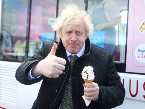 Prime Minister Boris Johnson gives a thumbs-up gesture after being served an ice cream (Tom Nicholson/PA)