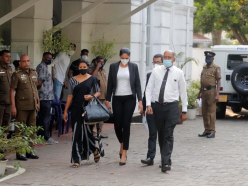 Mrs. World 2019 Caroline Jurie, center, leaves a police station after obtaining bail in Colombo, Sri Lanka, Thursday, April 8, 2021. Jurie’s decision to remove the crown from the the winning Mrs. Sri Lanka contestant on stage moments after the winner was announced, because of claims she was a divorcee, drew widespread social media condemnation. The winner Pushpika de Silva who was crowned again later had complained to police that her head was wounded when the clips of her crown were removed by Jurie. (AP Photo/Eranga Jayawardena)