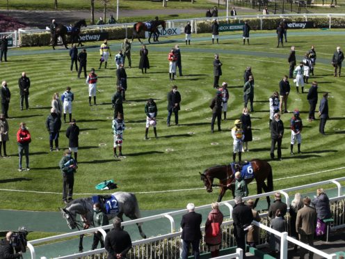 Racegoers and riders observe a two-minute silence for the late Prince Philip at the Grand National Festival (Tim Goode/PA)