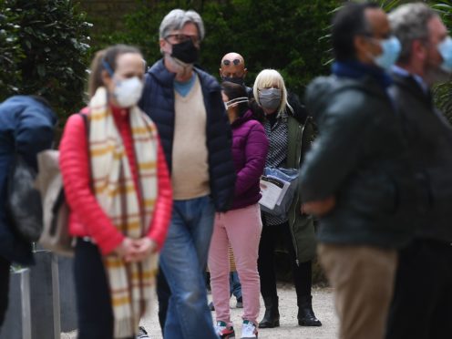 Members of the public queue for the Covid-19 testing centre at St John’s Church in Waterloo, south London (Victoria Jones/PA)