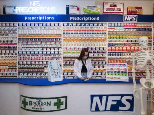 Gallery assistant Scarlett Taulbut behind the counter of artist Lucy Sparrow’s NHS themed felt chemist art installation (Kirsty O’Connor/PA)