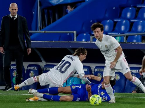 Zinedine Zidane, left, has vowed to continue to fight for the title despite drawing at Getafe (Manu Fernandez/AP)