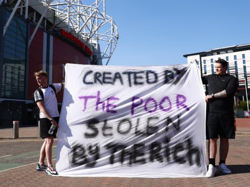 Football fans opposing the European Super League proposals outside Old Trafford in Manchester (Tim Markland/PA)