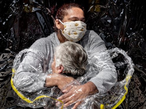 The winner of World Press Photo of the Year award, and the first prize in the General News Singles category, showing Rosa Luzia Lunardi embraced by nurse Adriana Silva da Costa Souza, at Viva Bem care home, Sao Paulo, Brazil (Mads Nissen, Politiken, Panos Pictures, World Press Photo via AP)