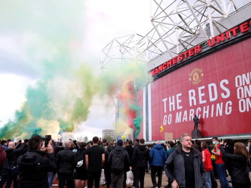 Fans let off flares (Barrington Coombs/PA)
