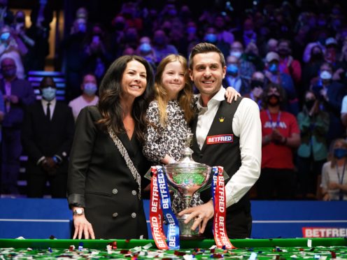 Mark Selby celebrates with his wife and daughter after winning the world title for a fourth time (Zac Goodwin/PA).