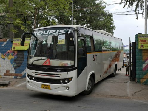 A bus assigned for transporting the members of broadcast team leaves Arun Jaitley Stadium (Ishant Chauhan/AP)