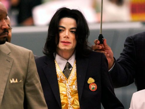 Michael Jackson arrives at the Santa Barbara County Courthouse for his trial in Santa Maria, California (Aaron Lambert/Santa Maria Times via AP, Pool, File)