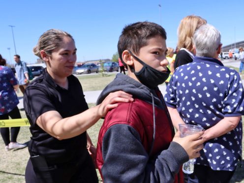 Adela Rodriguez, left, walks with her son, Yandel Rodriguez, 12, at the school where pupils were shot (Natalie Behring/AP)