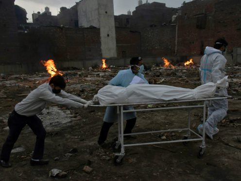 The body of a COVID-19 victim is wheeled into a converted crematorium in New Delhi (AP)