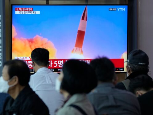 People watch a TV showing a file image of North Korea’s missile launch during a news program at the Seoul Railway Station in Seoul, South Korea (Ahn Young-joon/AP)