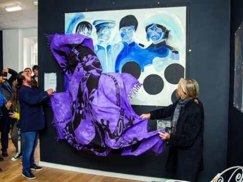 A painting of the Beatles by artist Jonathan Hague is unveiled at the Beatles Museum in Liverpool (Peter Byrne/PA)