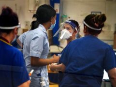 Medical staff wearing PPE on a ward for Covid patients at King’s College Hospital, in south east London (Victoria Jones/PA)
