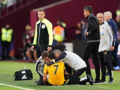 Wolves’ Pedro Neto receives treatment for his ankle injury against West Ham (Zac Goodwin/PA)