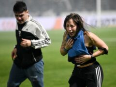 Fans of Gimnasia choked on tear gas during a match against Boca Juniors in La Plata (Gustavo Garello/AP)