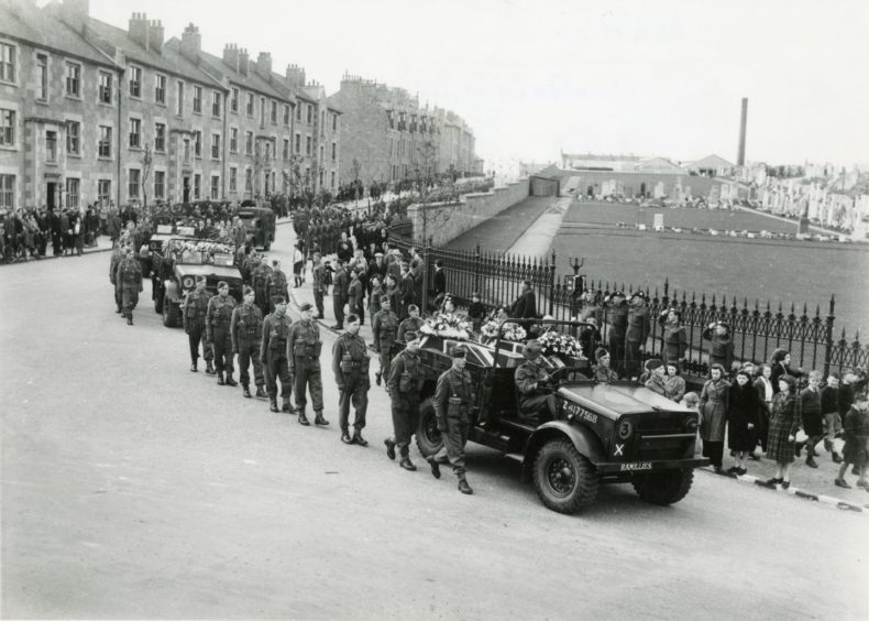 A funeral for victims of the Aberdeen Blitz shows mourners moving towards Trinity Cemetery in May 1943.