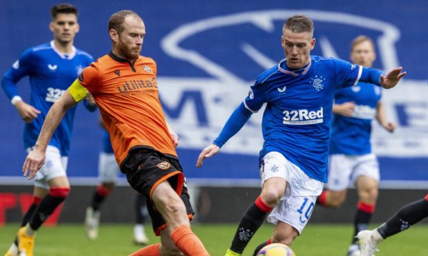 Dundee United captain Mark Reynolds in action against Rangers.