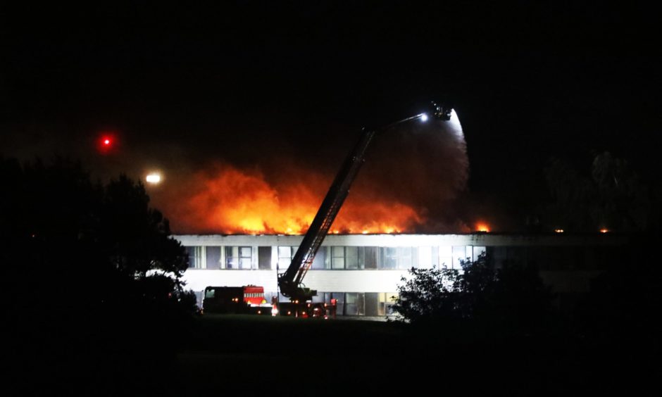 A Braeview Academy building on fire at night