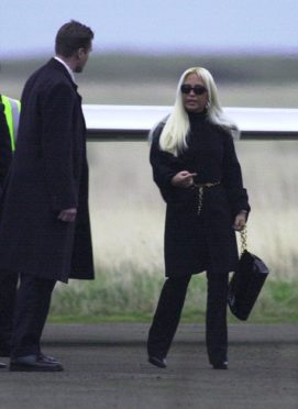 Donatella Versace stepping out of a private jet at Wick Airport on the day of Madonna and Guy Ritchie's wedding.
