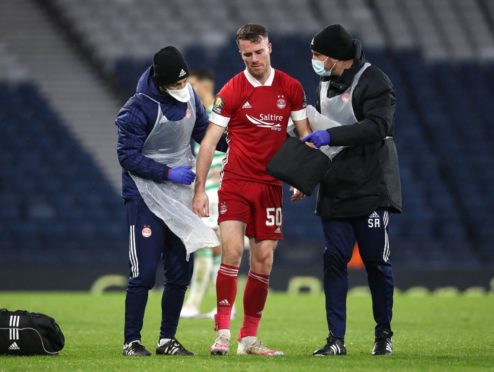 Aberdeen's Marley Watkins is helped off the pitch after suffering an injury during the William Hill Scottish Cup semi-final match at Hampden Park, Glasgow.