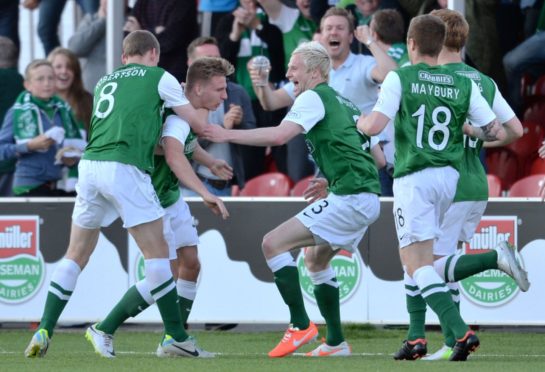 Scott Robertson (left) and Ryan McGivern celebrate with Jason Cummings (centre) after his goal against Hamilton.
