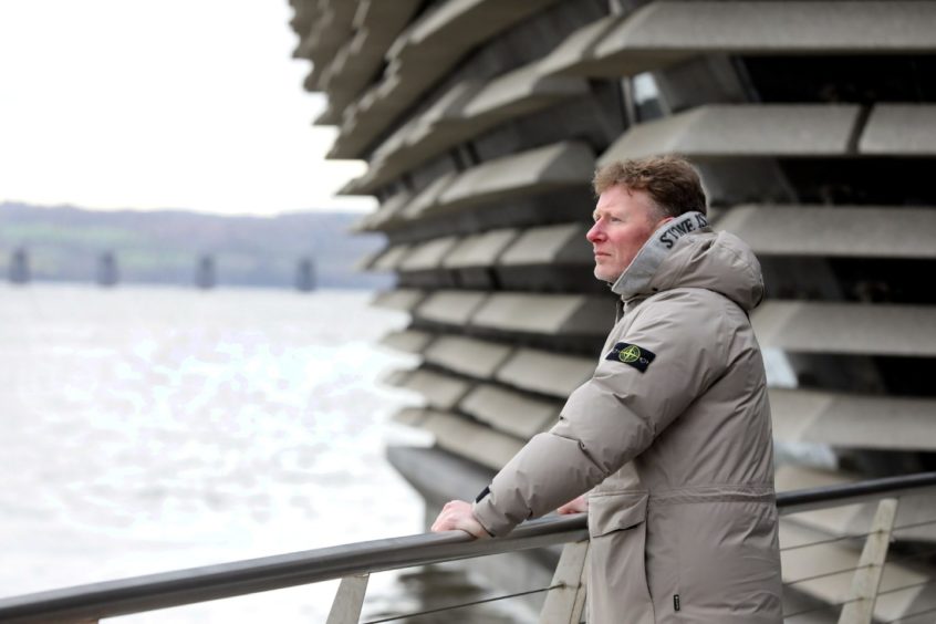 Gordon Morris beside the River Tay, with the V&A Museum in the background.